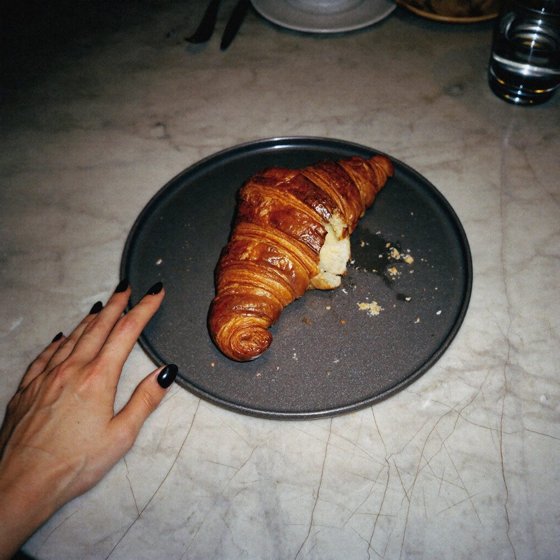 Sat pastry — a flash-lit croissant with a bite taken